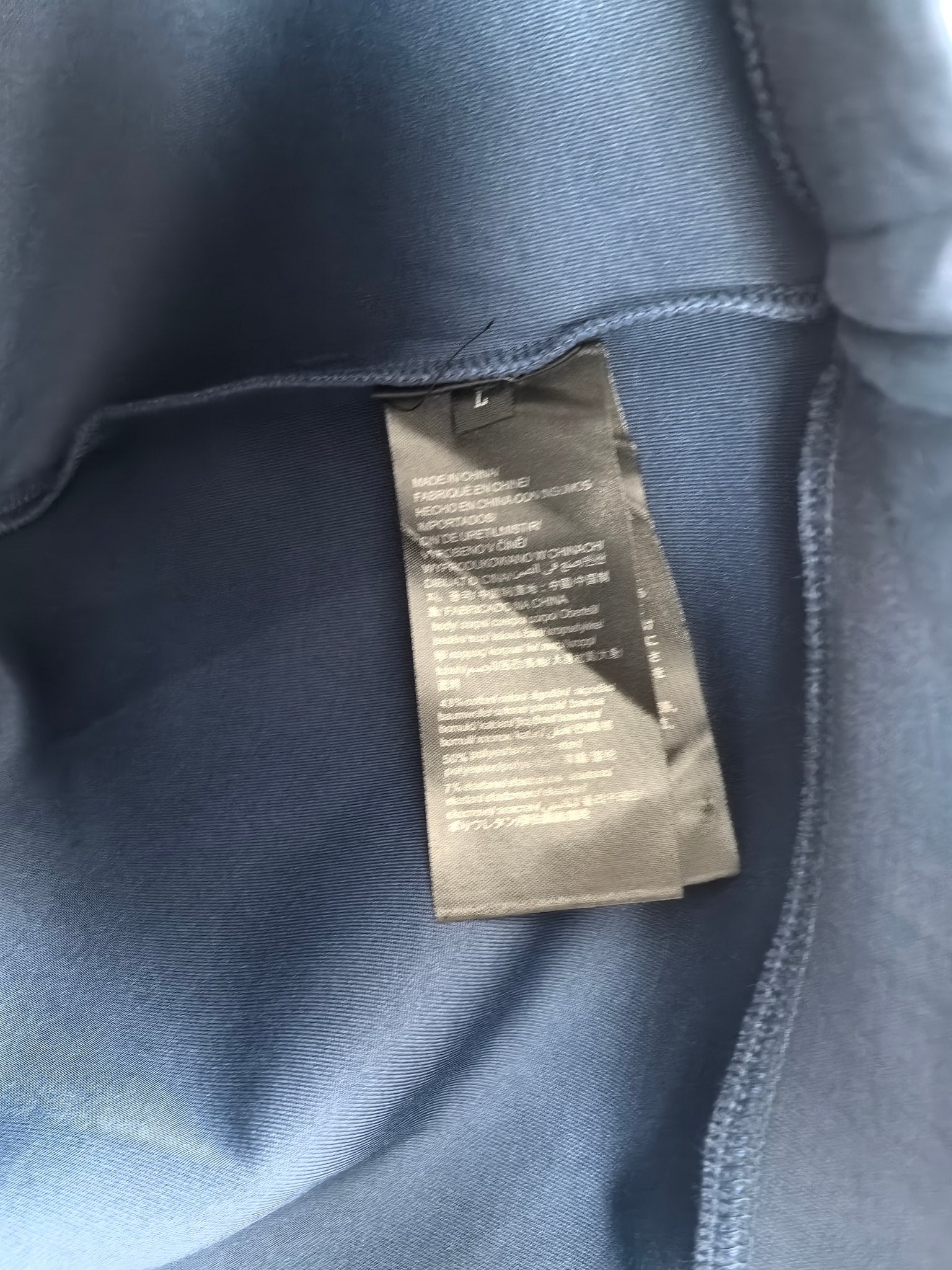 Blue Louis Vuitton crewneck sweatshirt with interior care label near collar
