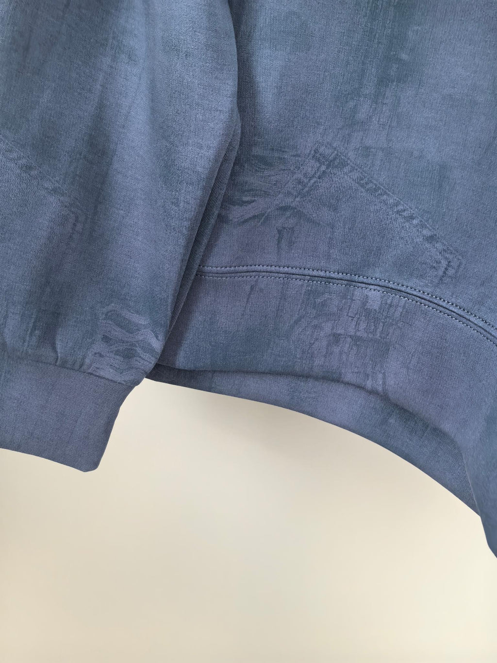 Blue Louis Vuitton long-sleeve sweatshirt hem and side seam close-up