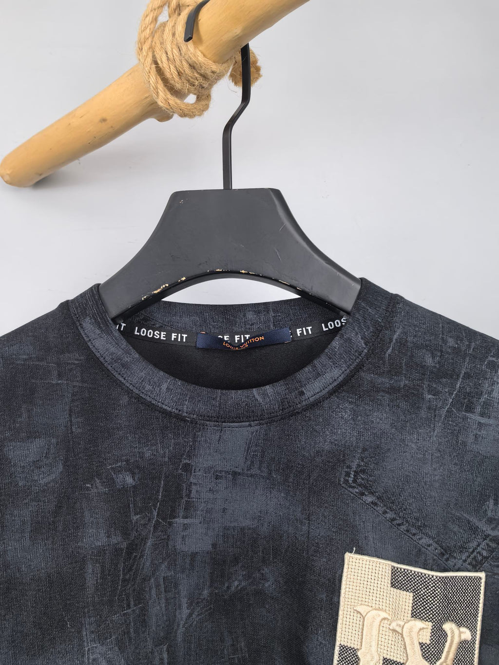 Dark navy sweatshirt neckline with black interior tag and “FIT” text