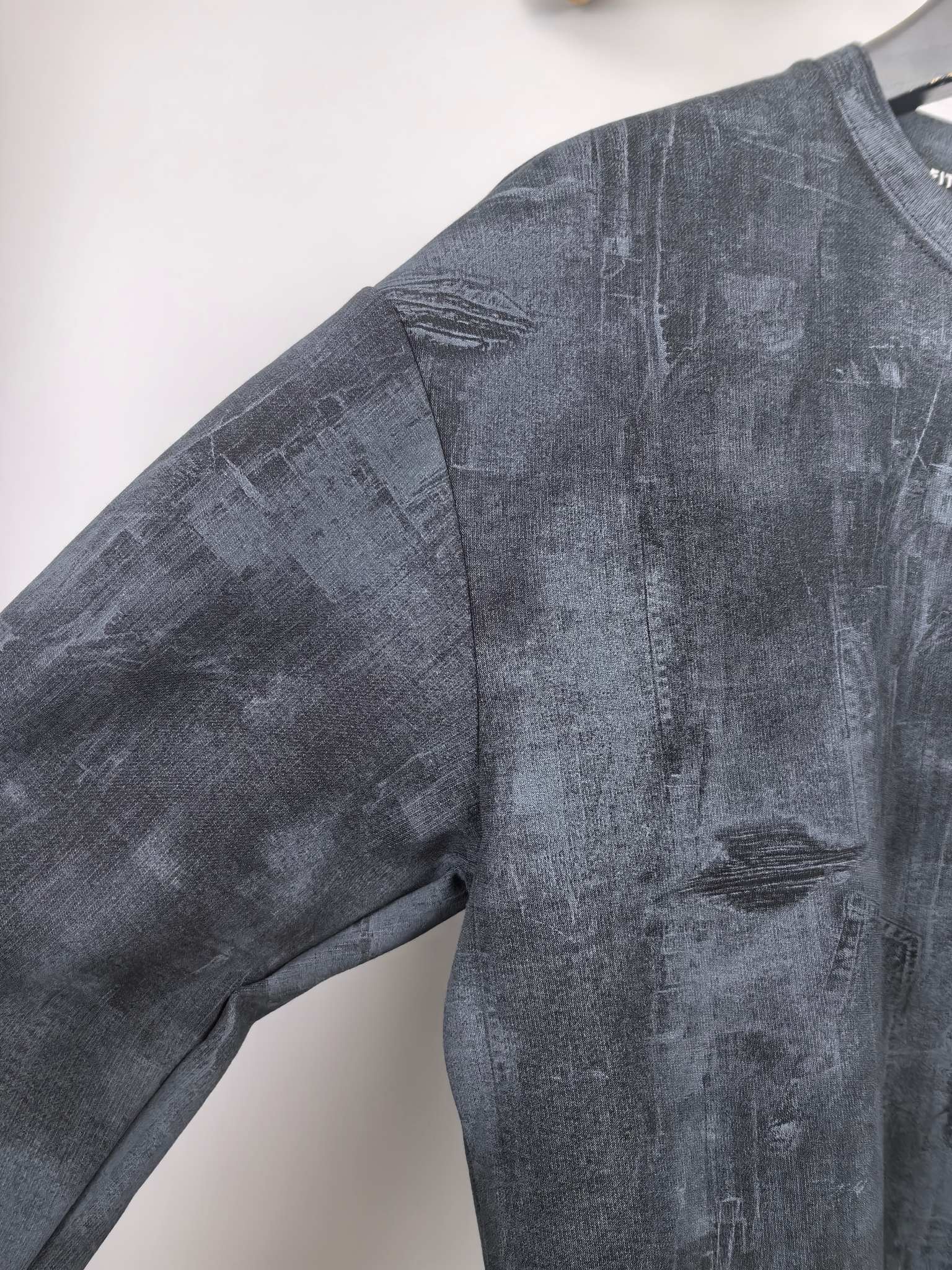 Dark navy long-sleeve sweatshirt with stitched shoulder seam and relaxed fit