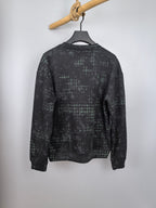 Black long-sleeve sweatshirt with green grid pattern, crew neck, back view