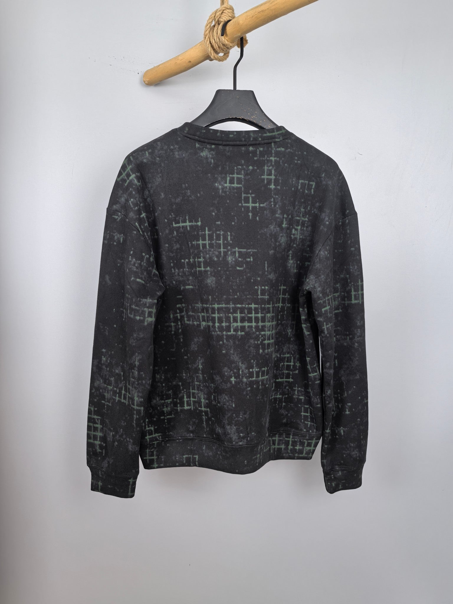 Black long-sleeve sweatshirt with green grid pattern, crew neck, back view