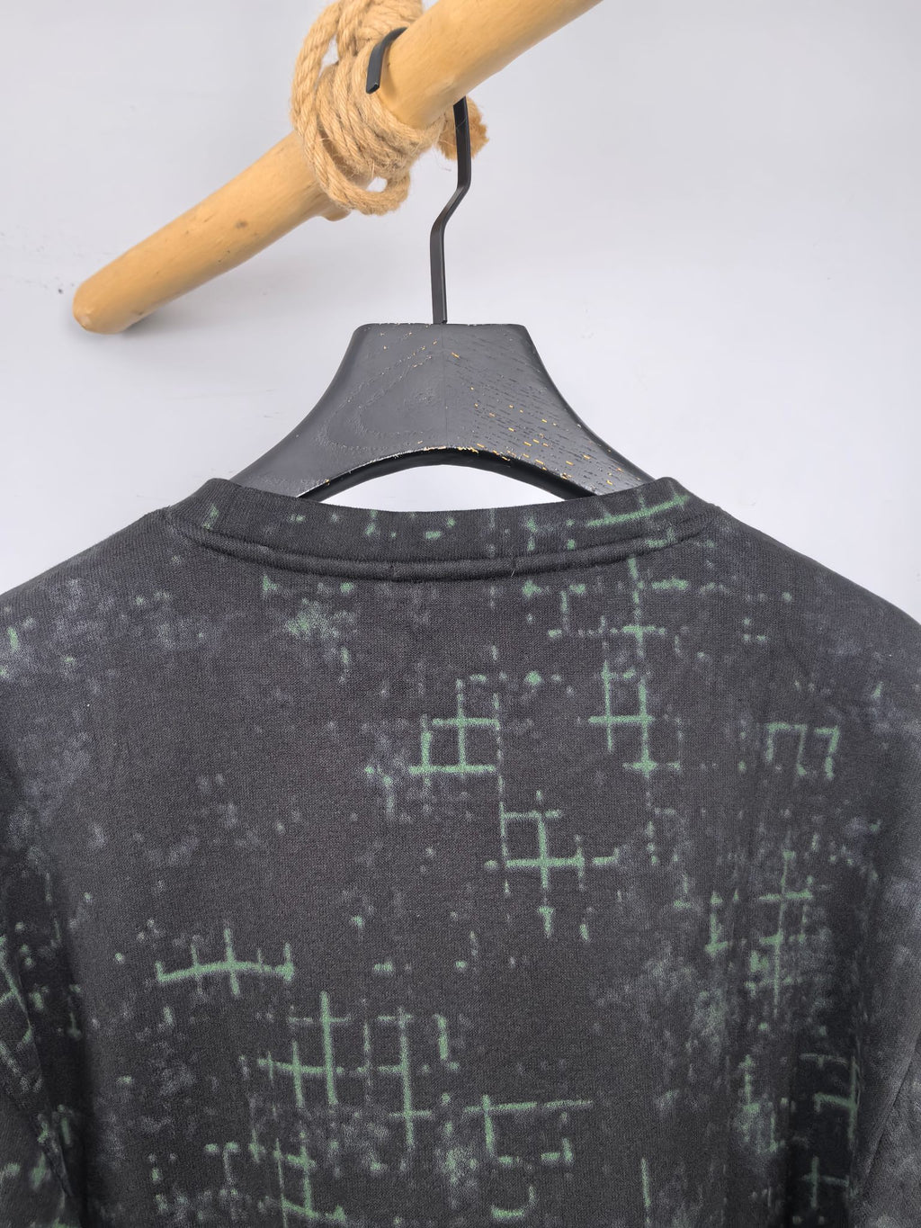 Black sweatshirt back with green grid pattern, crew neck view