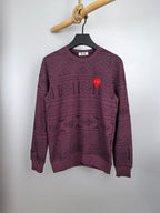 Maroon knit sweater with geometric pattern, crew neck, long sleeves, and red heart patch