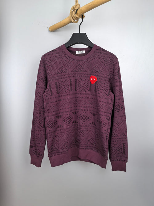 Maroon knit sweater with geometric pattern, crew neck, long sleeves, and red heart patch