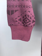 Maroon knit sweater hem and cuff with geometric texture pattern