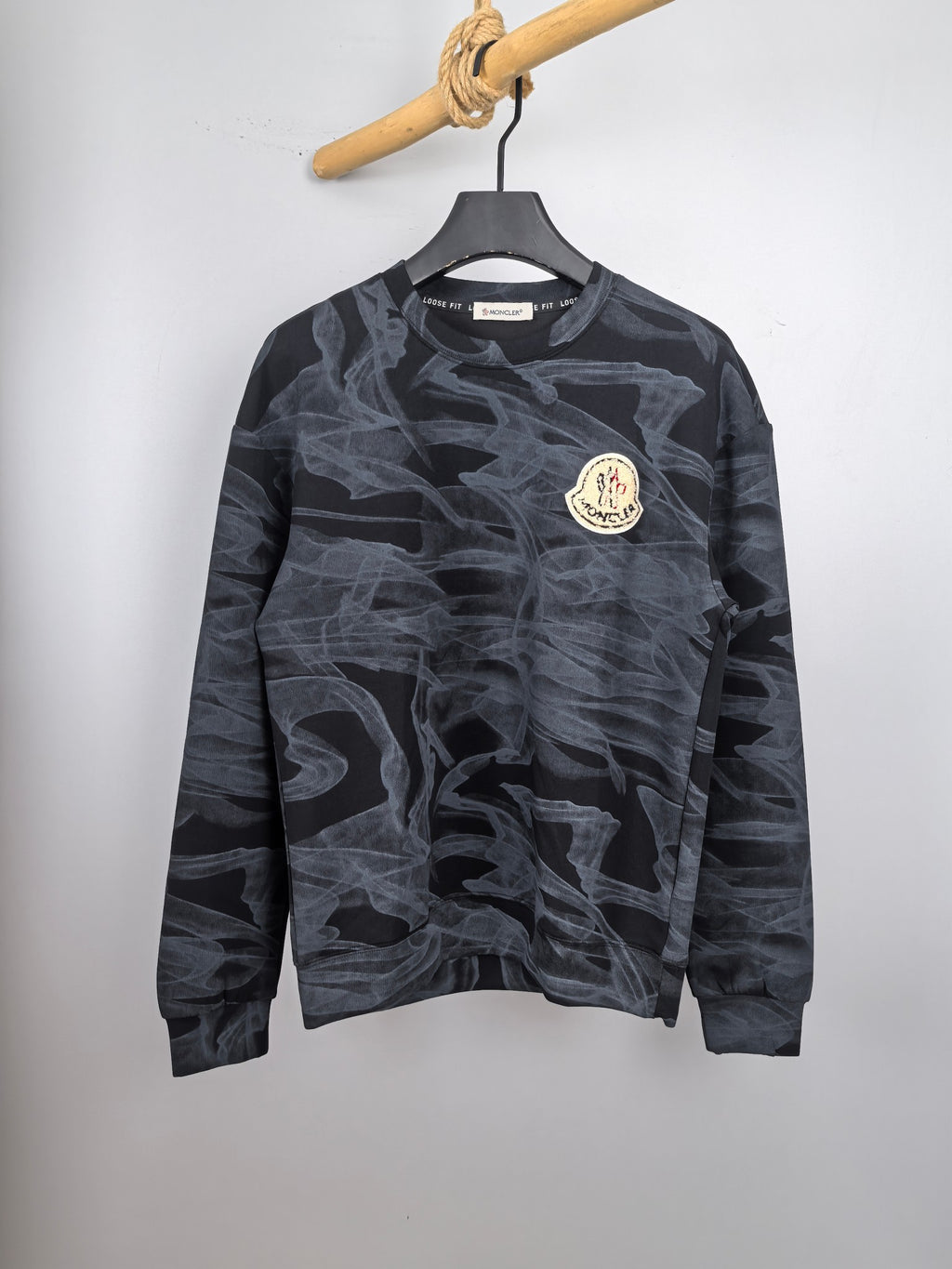 Moncler long-sleeve top, dark with light abstract pattern and round chest logo patch