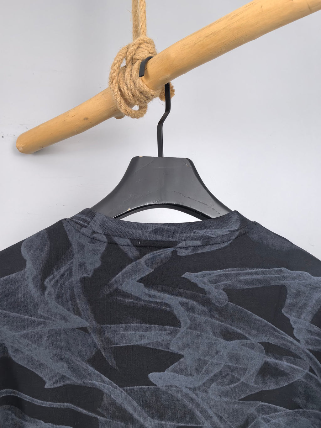 Long-sleeve top back view with dark abstract print across shoulders