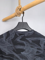 Long-sleeve top back view with dark abstract print across shoulders