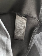 Long-sleeve top interior care label on dark fabric
