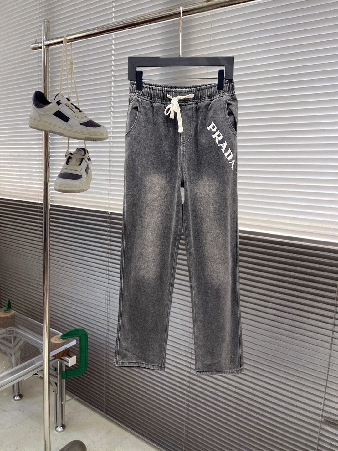 Gray denim pants with elastic waistband and white drawstring