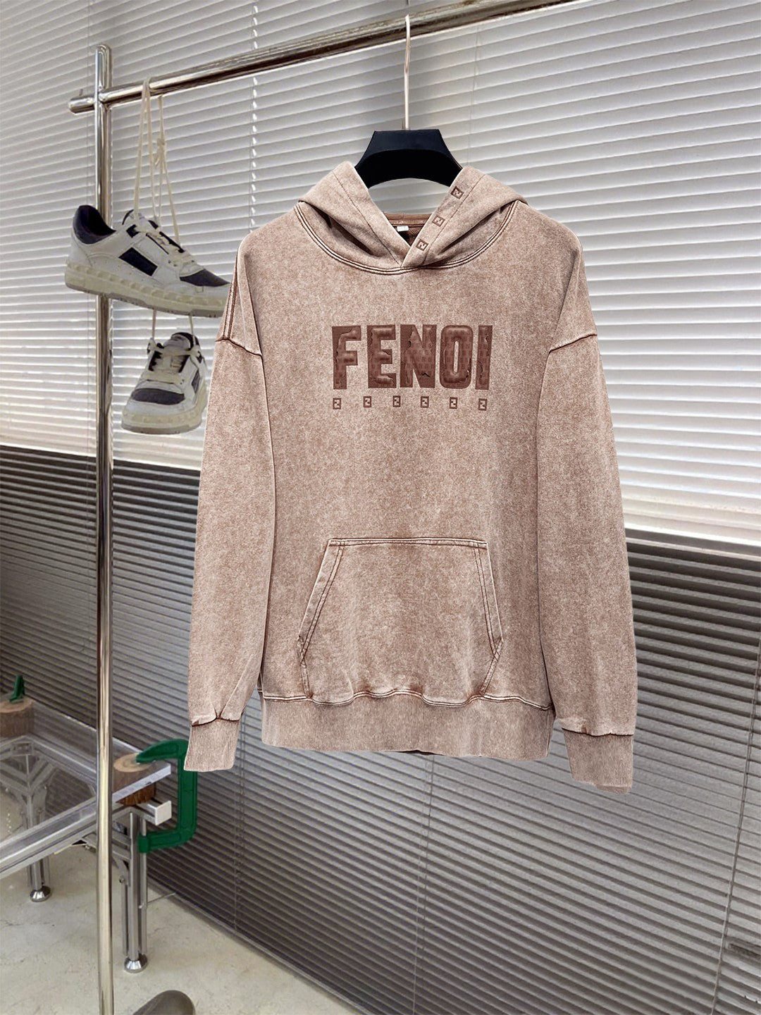 Beige FENDI long-sleeve hoodie sweatshirt on a hanger, front pocket and hood.
