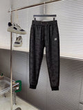 Black Dior monogram jogger pants with elastic waistband and tapered legs