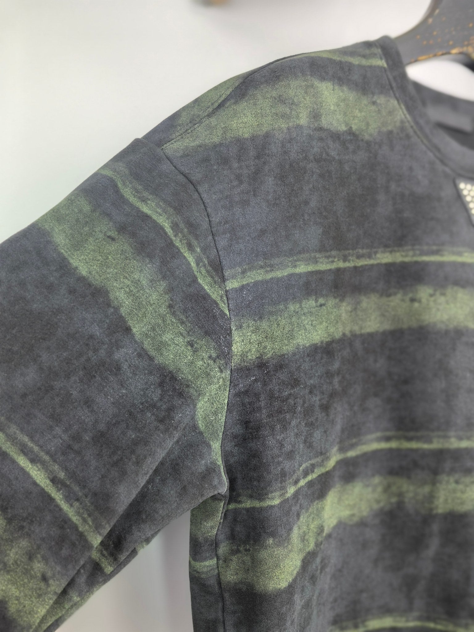 Prada sweatshirt sleeve and torso, dark gray with green striped bands.