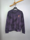 Purple long-sleeve sweatshirt on hanger, front view with small chest patch logo.