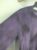 Purple long-sleeve sweatshirt with side seam detail near hip.