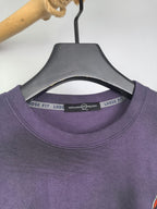 Purple sweatshirt crew neck with size label tape inside collar.