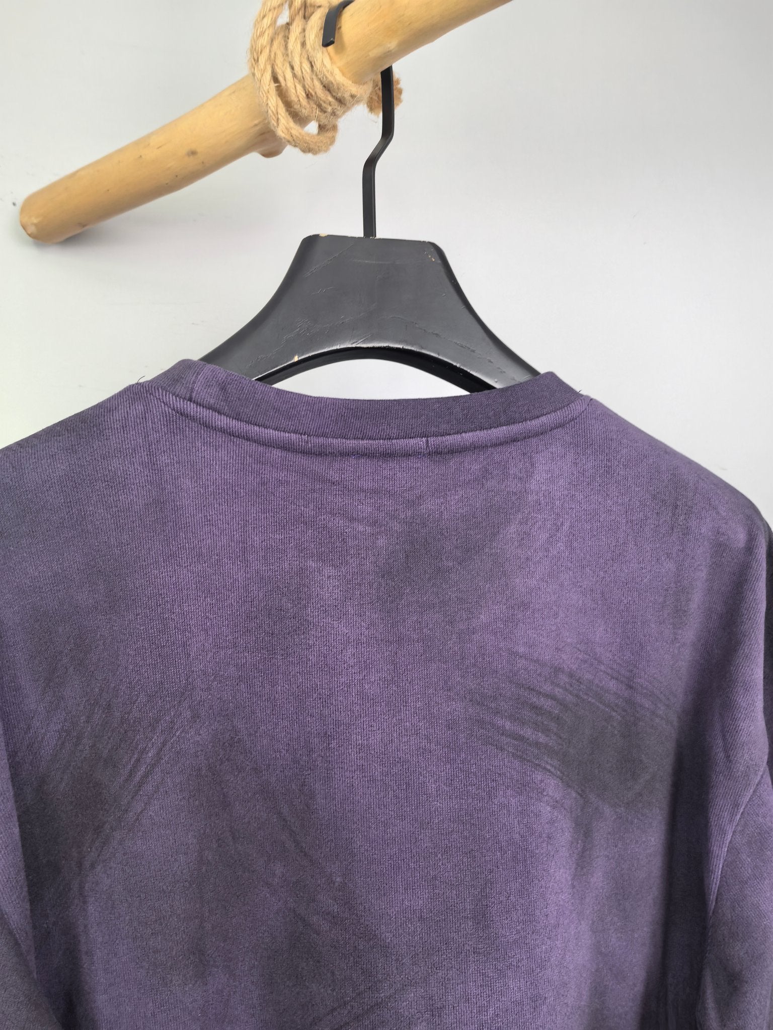 Purple sweatshirt back view on hanger, crew neckline and shoulder seam.