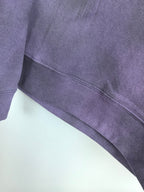 Purple sweatshirt ribbed waistband and stitched hem edge detail.