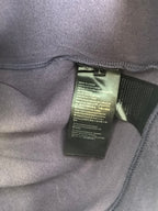 Purple sweatshirt inside neck label tag sewn to inner seam.