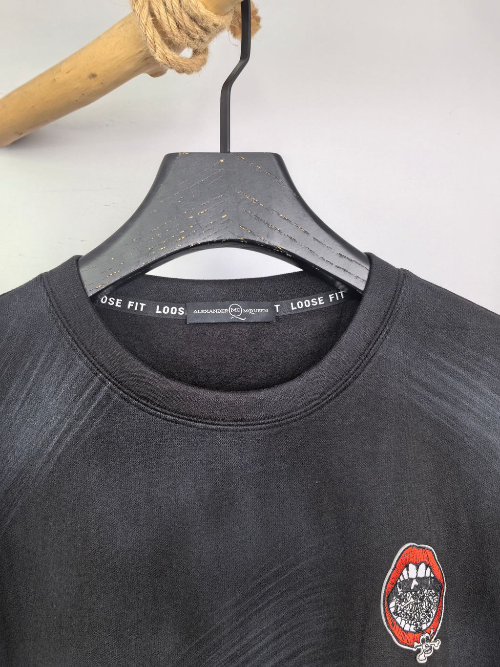 Long-sleeve crewneck shirt neckline and chest patch graphic, dark charcoal knit
