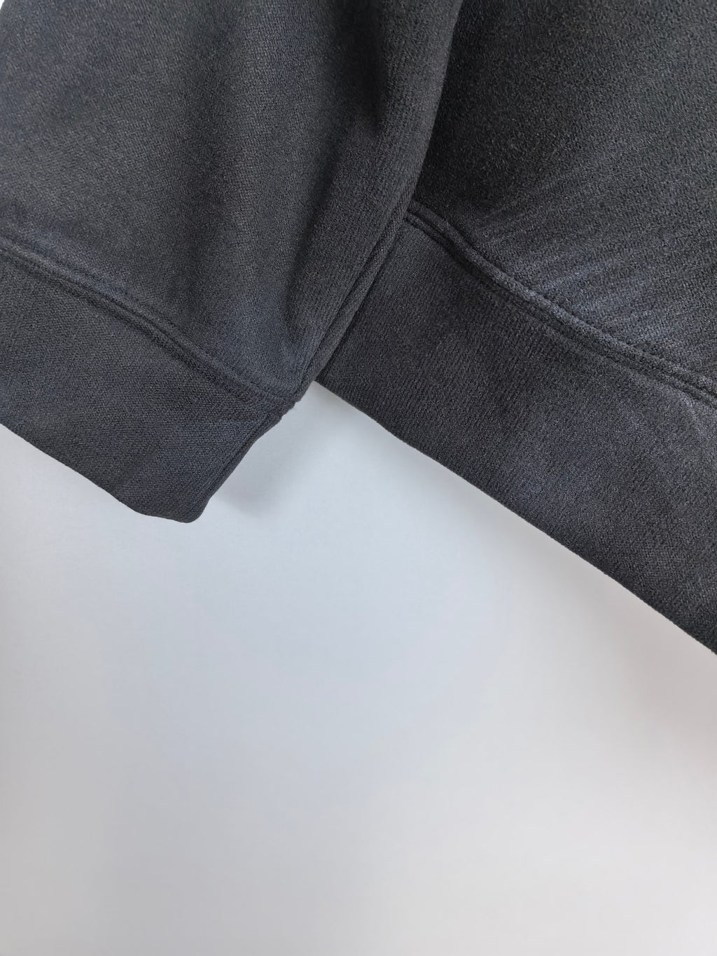 Long-sleeve crewneck shirt sleeve and side seam detail, dark charcoal
