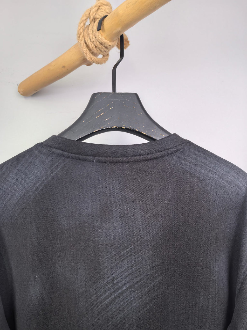 Long-sleeve crewneck shirt back view, dark charcoal with neckline collar