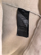 Light beige sweatshirt interior: black care label sewn at side seam.
