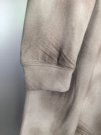 Light beige sweatshirt sleeve cuff and hem with ribbed trim detail.