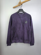 Purple long-sleeve crewneck sweatshirt with patch at left chest on hanger