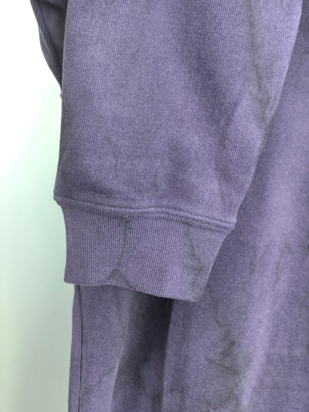 Purple sweatshirt hem with ribbed cuff and lower sleeve seam detail