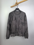 Dark gray marble print crewneck long-sleeve sweatshirt with small chest badge