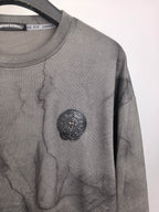 Dark gray marble crewneck sweatshirt with round embossed-style logo on chest