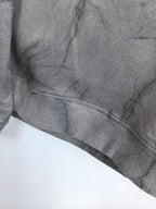 Dark gray marble print sweatshirt hem with ribbed band and curved stitching