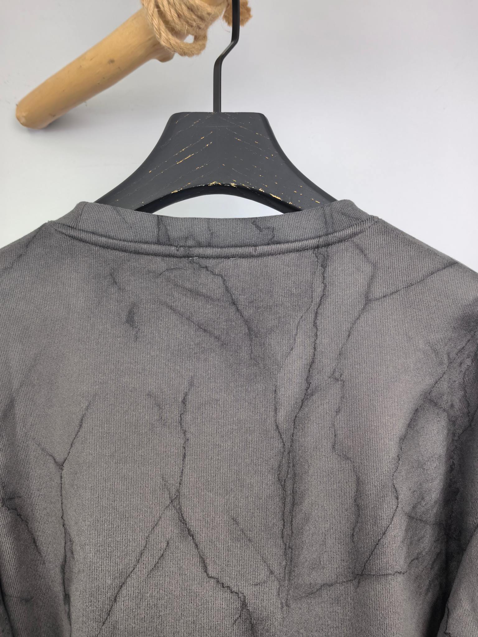 Dark gray marble print long-sleeve sweatshirt with crew neckline, back view