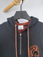 Dark gray zip hoodie with orange drawcords, metal zipper, and Burberry chest logo