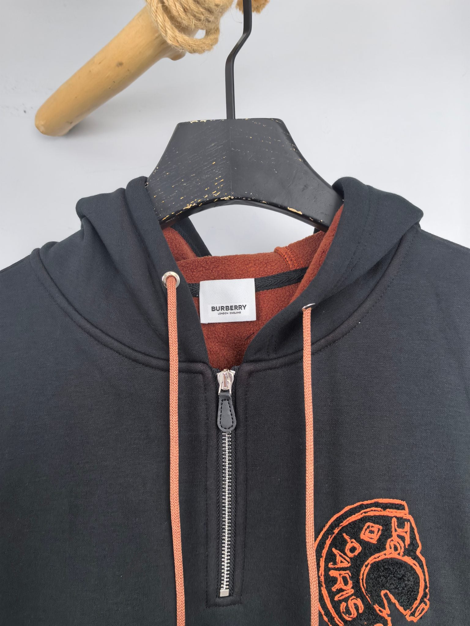 Dark gray zip hoodie with orange drawcords, metal zipper, and Burberry chest logo