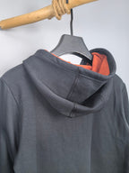 Dark gray hoodie back with orange hood lining and ribbed collar