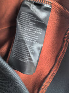 Burberry hoodie interior care label with orange fabric lining near zipper