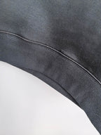 Dark gray hoodie waistband with ribbed knit trim and curved hem
