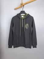 Dark gray zip-up hoodie with hood, neon green drawstrings and embroidered logo patch