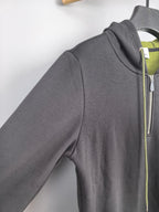 Dark gray zip-up hoodie side view with front zipper and neon green drawstring trim