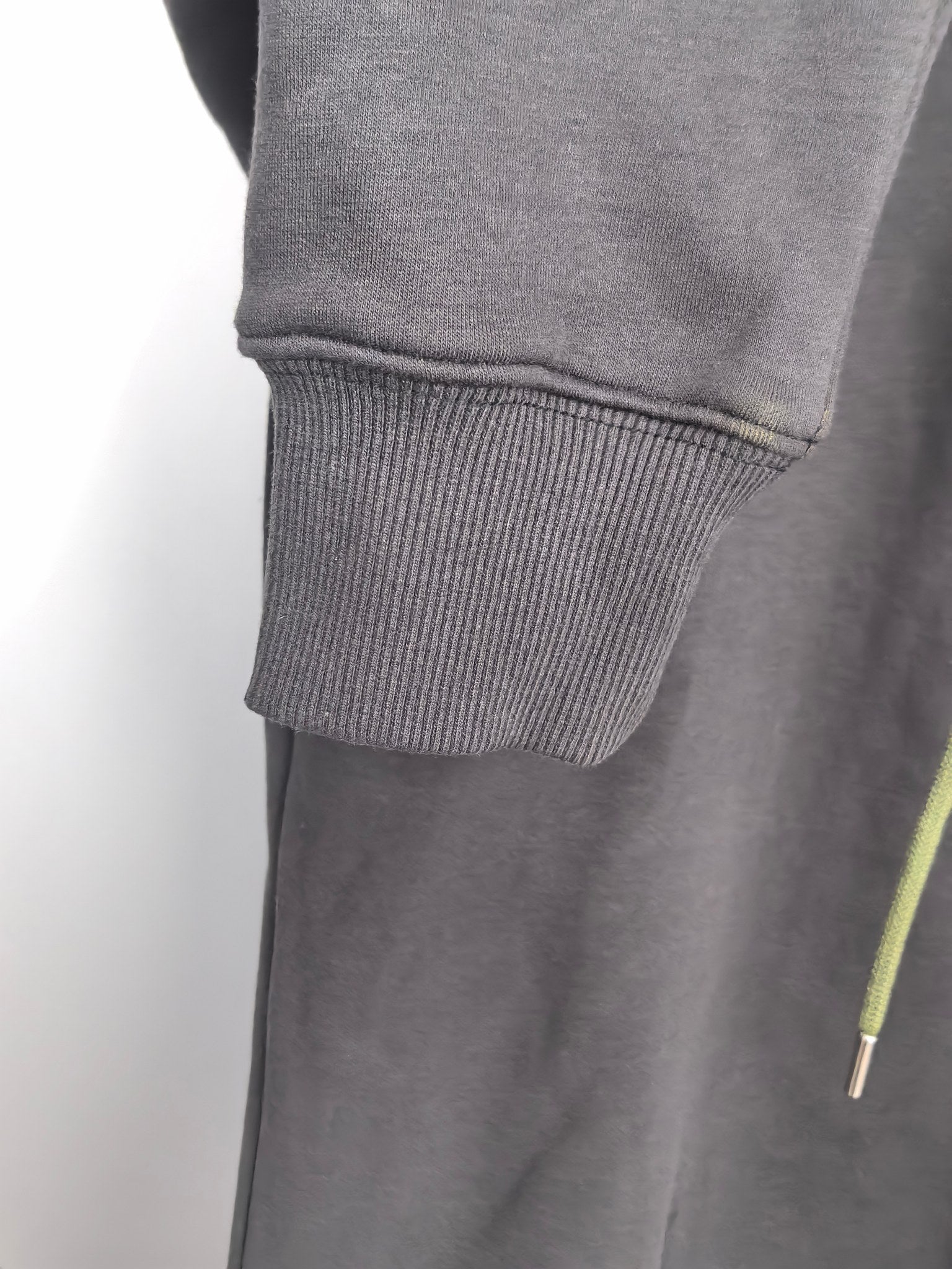 Dark gray zip-up hoodie with ribbed cuffs and hem, plus neon green drawstring