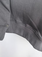 Dark gray hoodie hem with ribbed knit band and curved seam detail