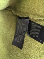 Neon green fleece lining with black care labels inside the hoodie