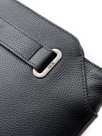 Black Dior leather bag detail with silver-tone logo buckle on flap.