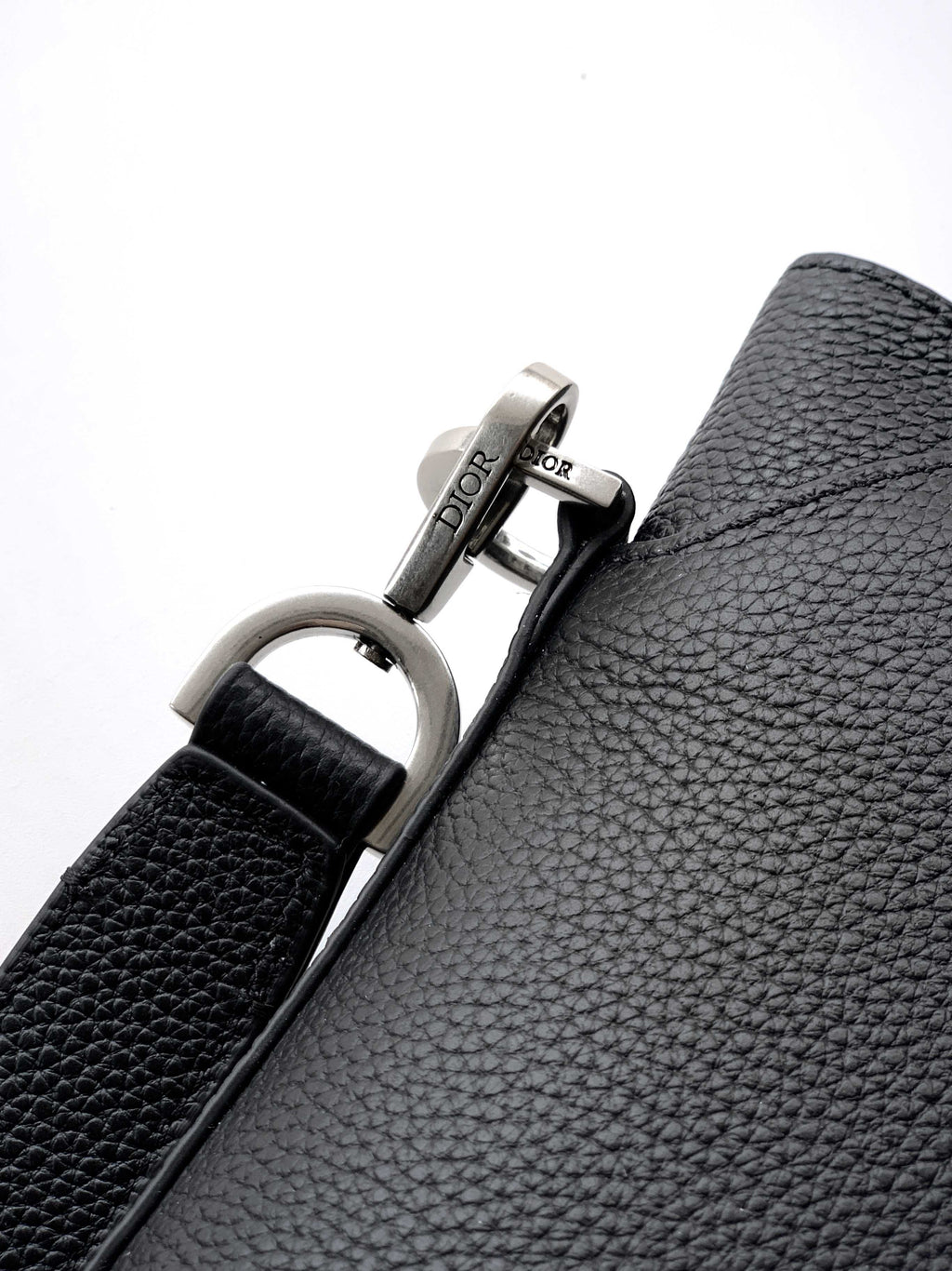 Dior bag strap hardware with silver D-ring and Dior engraved plaque.