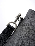 Dior bag strap hardware with silver D-ring and Dior engraved plaque.