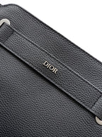 Black Dior leather strap panel with debossed Dior logo and visible stitching.