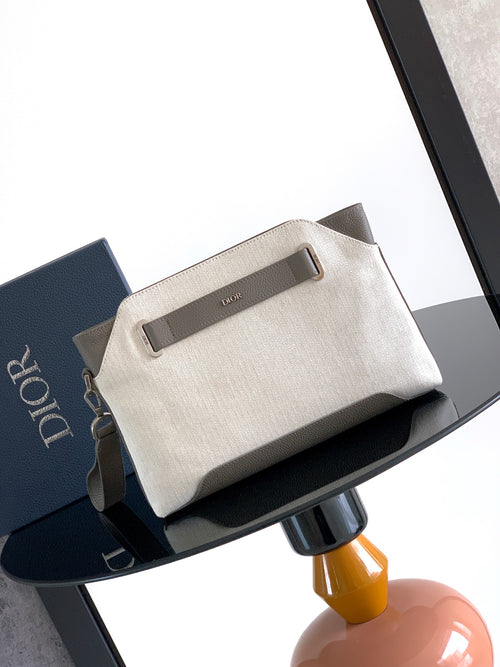 Dior men’s small zip pouch bag in light beige canvas with top handle tab